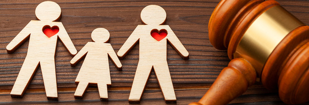 wooden figures of family next to gavel